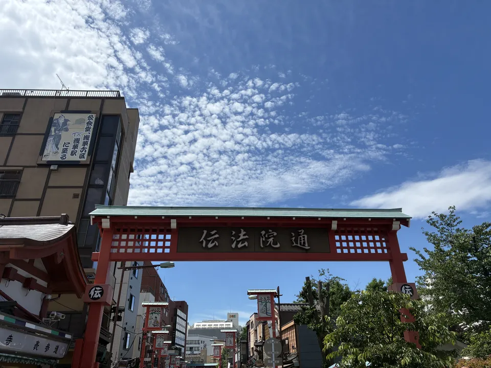 Red gate over Denboin-dori street in Asakusa under a blue sky