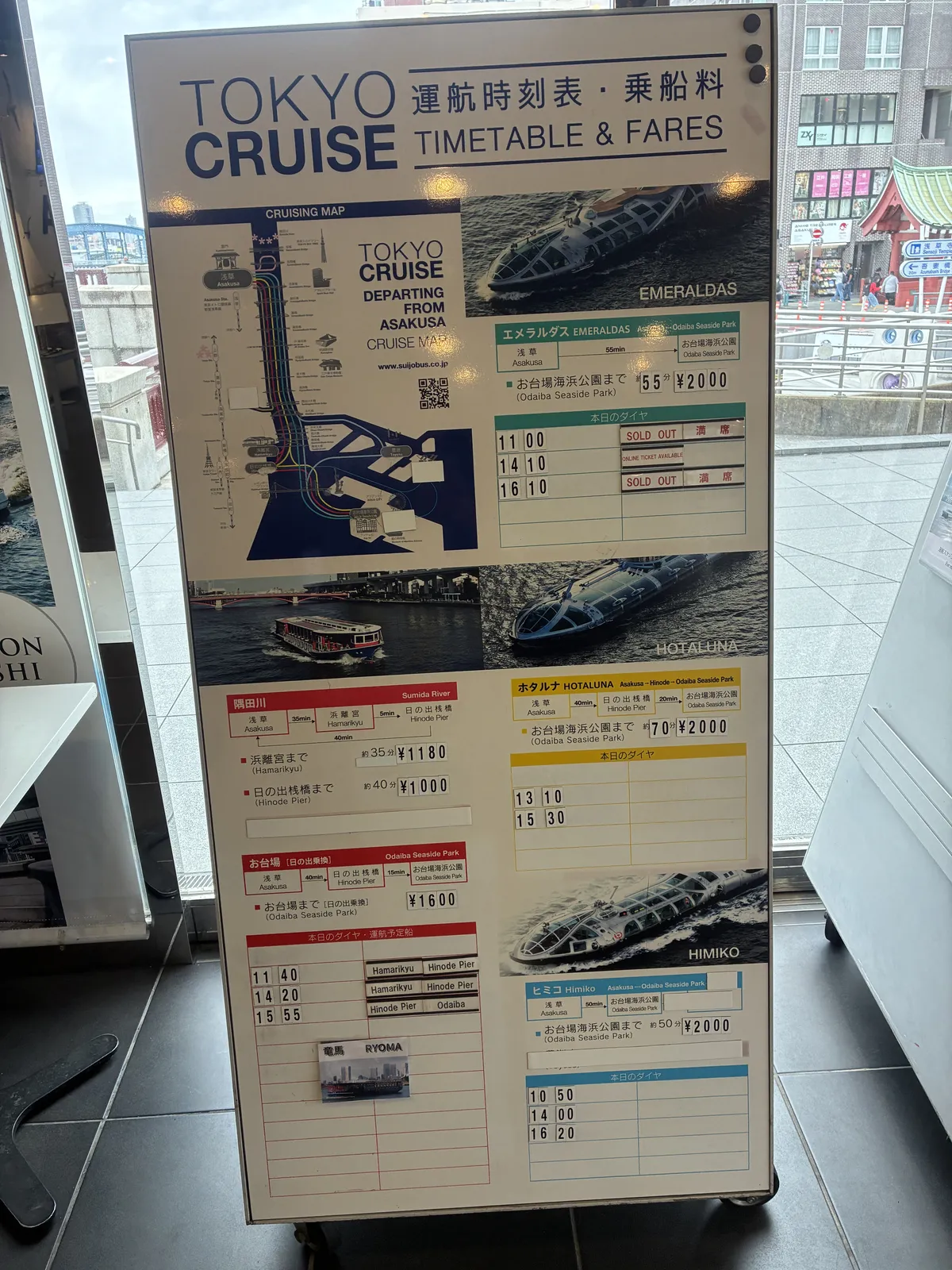 The timetable and fares board at Asakusa Pier. It shows each boat with a photo and its name (EMERALDAS, HOTALUNA, HIMIKO, and the RYOMA card at the lower left), plus the route, time, fare and the day’s departures.